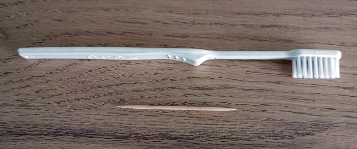 Photo des ustensiles (brosse à dents et cure-dent) pour réparer fuite d'eau Nespresso Lattissima De'Longhi